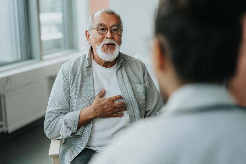 Older man talking to doctor