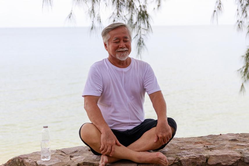 Man meditating outside.
