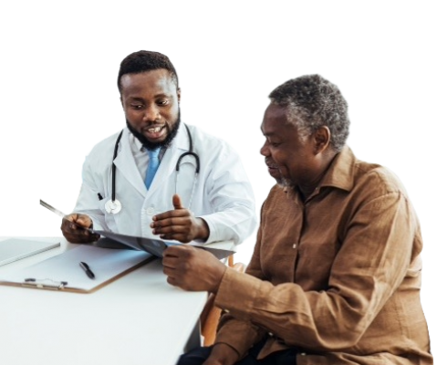 A doctor and patient sitting at a table reviewing documents
