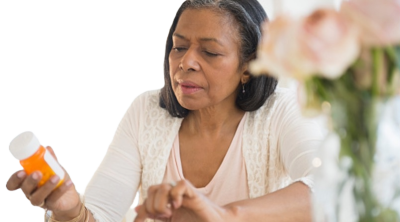 A women reviewing the details on her rx pill bottle